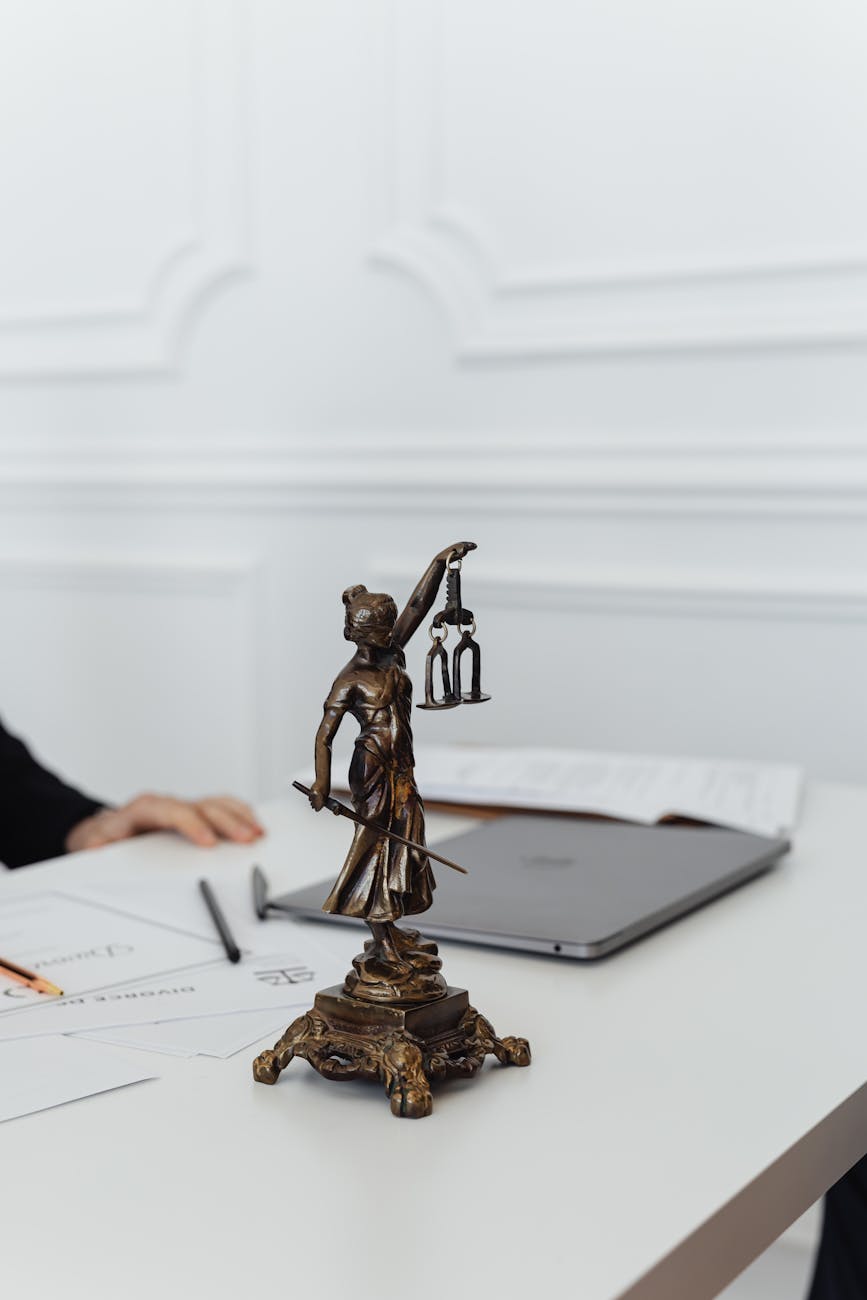 close up shot of a lady justice figurine on a white table
