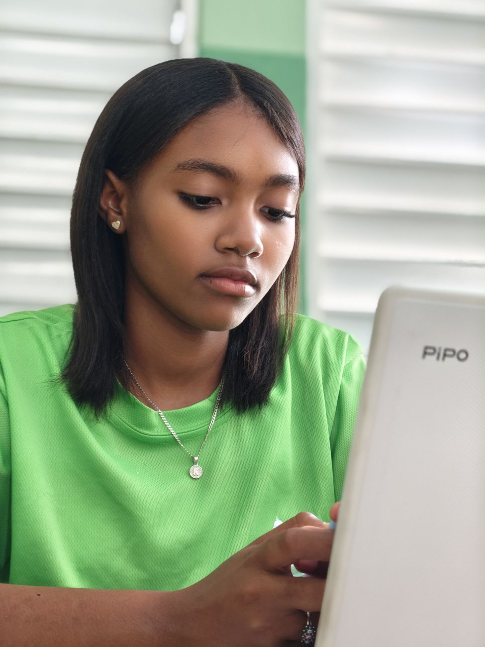 young woman engaged with laptop indoors