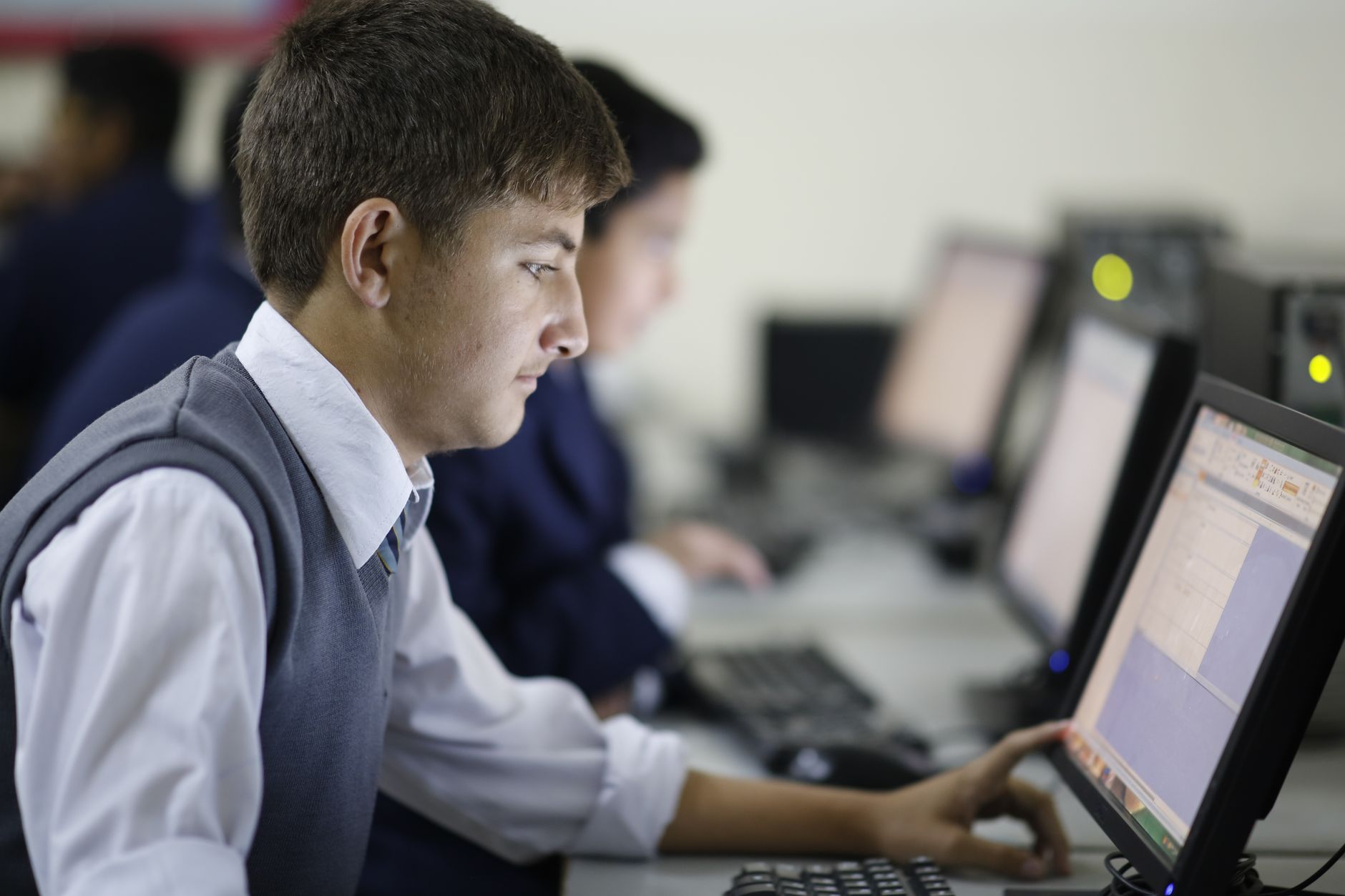 young man using a computer in a classroom