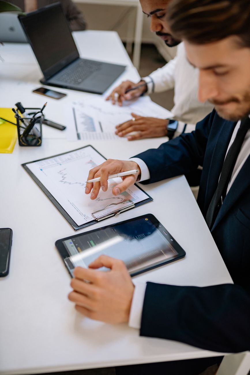 a businessman looking at a tablet while working at an office