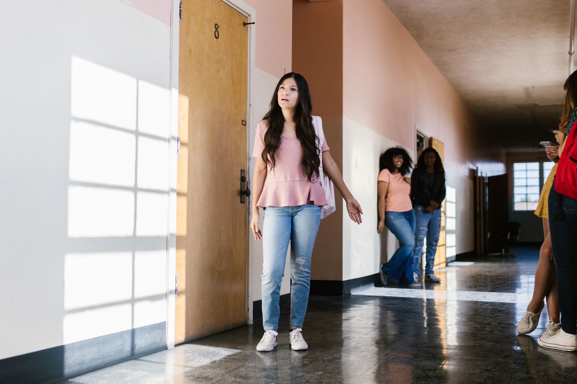 upset teenager in high school corridor