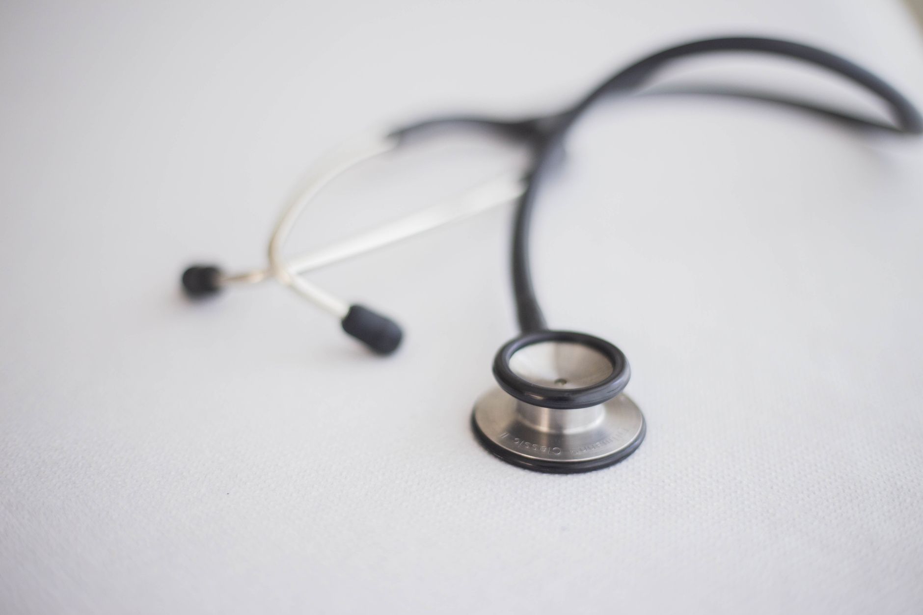 close up of a stethoscope lying on a white surface