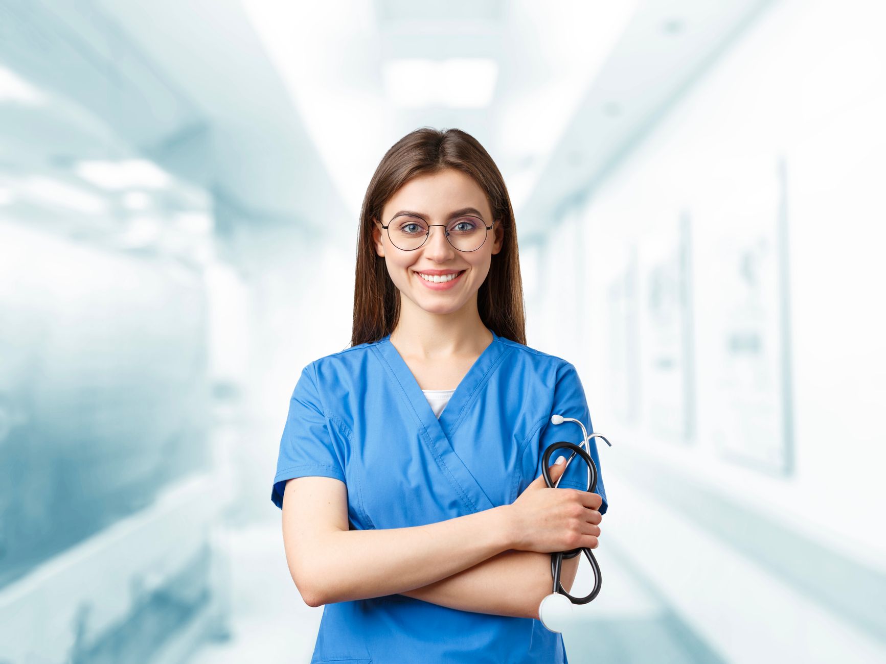 a young woman in blue scrubs holding a stethoscope
