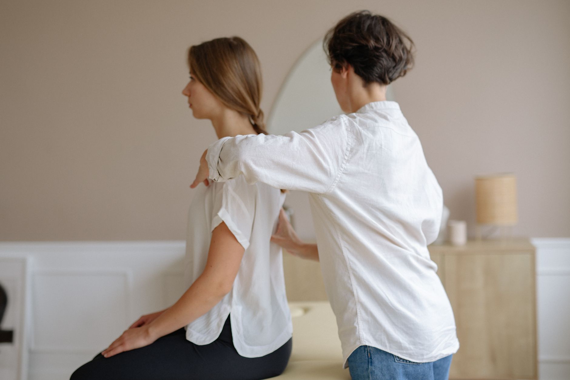 a woman sitting and getting a massage