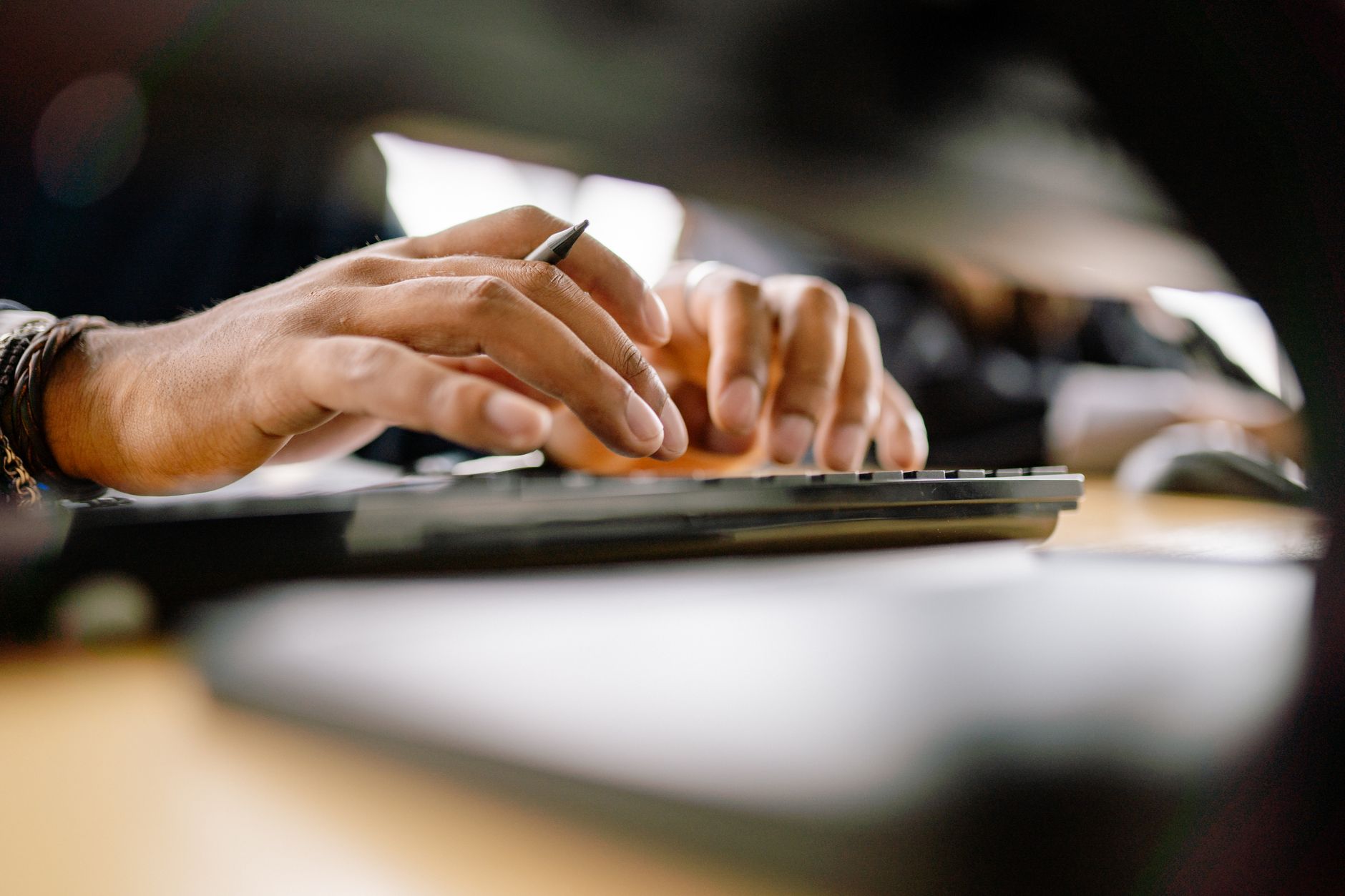 close up shot of hands typing on keyboard